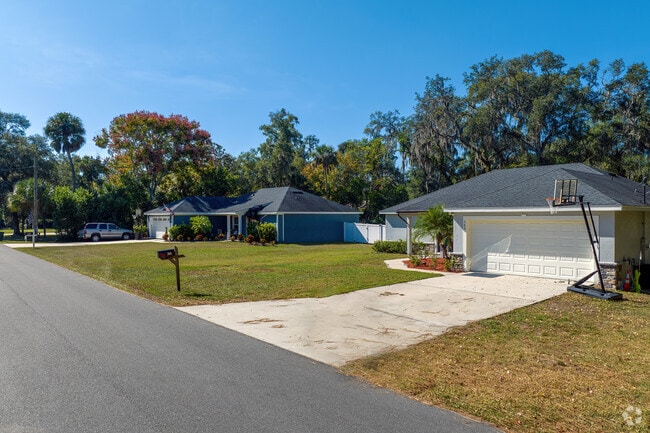 Newly constructed homes in Geneva are well maintained and shaded by mature trees.
