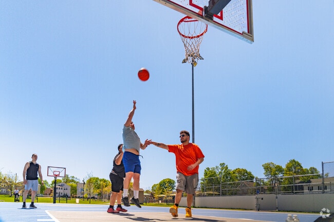 Residents head to Lowell Playground to shoot some hoops with friends at the recreational basketball courts.