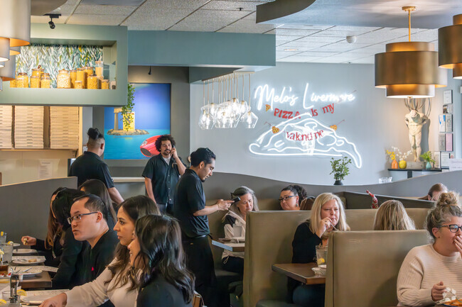 Melo's Pizza is bustling at lunchtime with patrons of the area.
