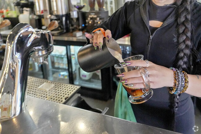 A bartender makes a latte at Lost Shoe Brewing.