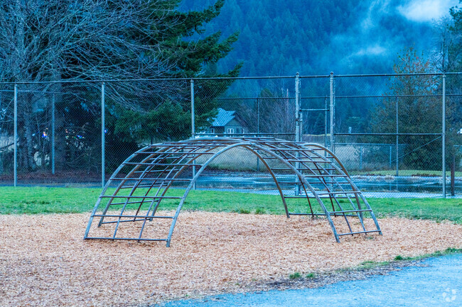 A climbing structure sits in the playground.