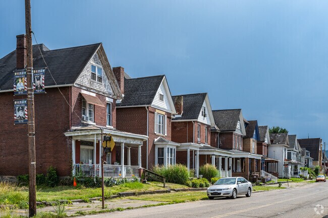A row of workmen's cottages stands in Wellsville.