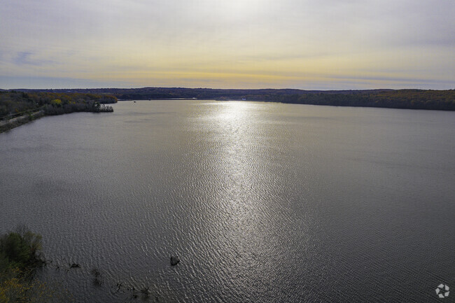 Enjoy the sun setting over the tranquil Arnold Mills Reservoir.