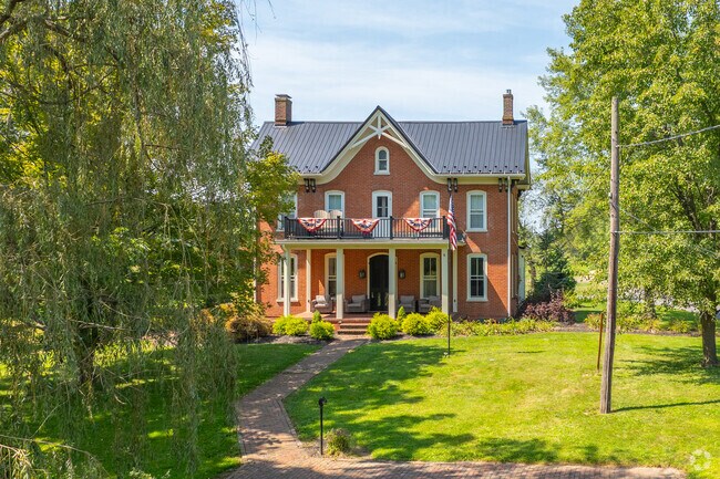 Classic colonials in Muncy sit beneath shaded oaks.