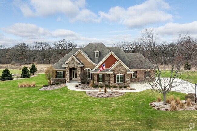 A perfect Tudor-style home stands proudly in Mukwonago Township.