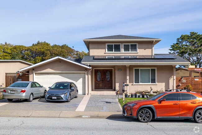 Solar panels enhance this Millbrae Meadows home, blending efficiency with contemporary design.