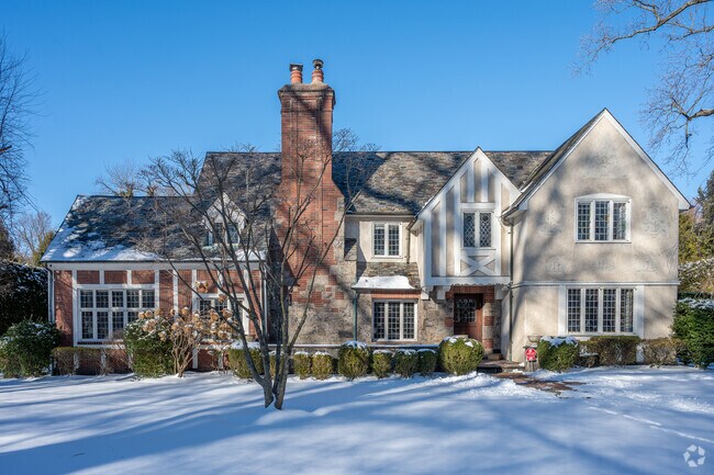 This stunning Tudor Revival is located on Harcourt Road in Fox Meadow.