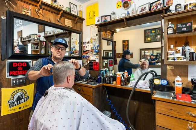 A barber cuts a client's hair at Teddy's Barbershop near Brookline.