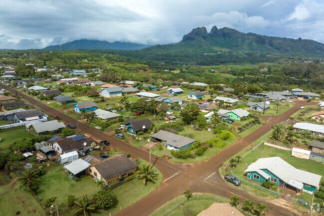 farm-style homes with mountains in the background
