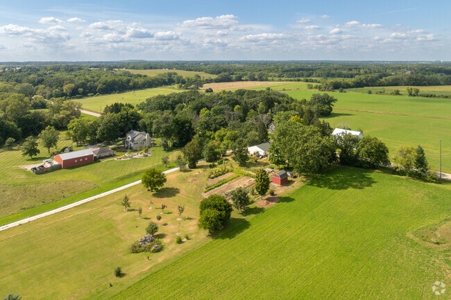 Aerial view of Raymond farmland shows patchwork of fields and spacious residential lots.