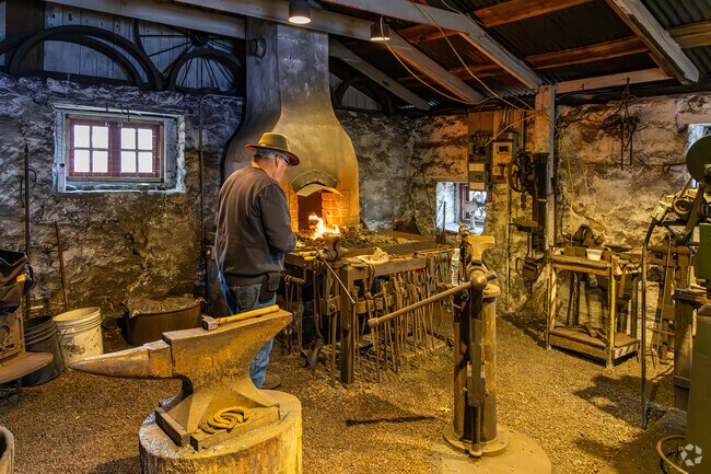 The Winter Village at Red Mill Museum features a blacksmith demonstration.