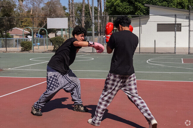 Young men at Addams often practice boxing and other sports in local parks for recreation.