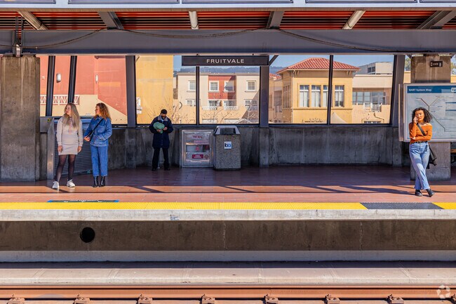 Commuters at Fruitvale BART: Oakland's pulse in Fremont neighborhood.