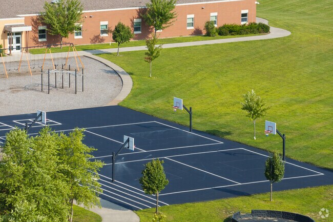 Bloomer Elementary School has a large recess area with sport courts.