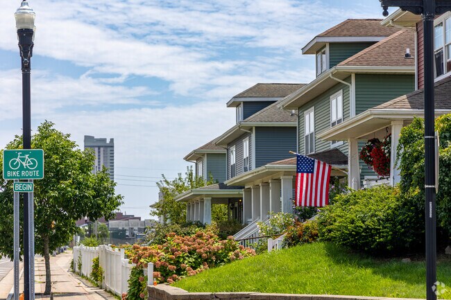 Large single family homes overlooking the sidewalks with a view of AC's condo towers.