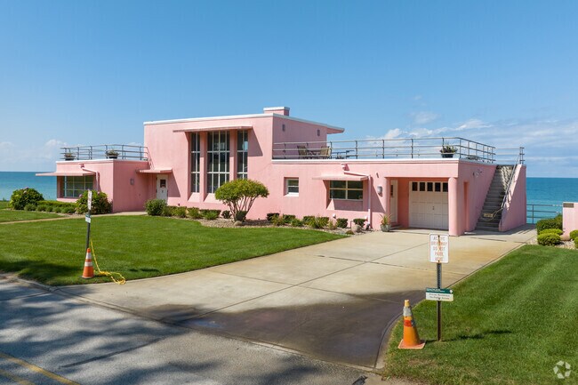 The historic pink house of the future faces Lake Michigan with views of the beach and dunes.