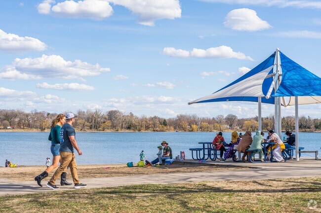 Lake Nokomis Beach has shaded picnic areas and walking paths that connect to other trail systems