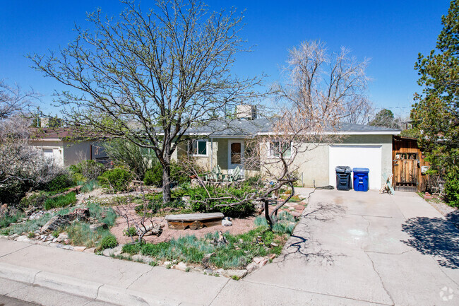 Grey Stucco Home with Decorated Yard in Mesa Village