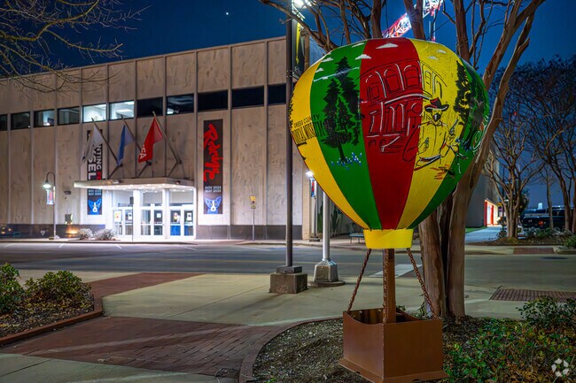 The Longview Museum of Art stands across the street, featuring a vibrant balloon sculpture celebrating the Great Texas Balloon Race held in Longview every June.