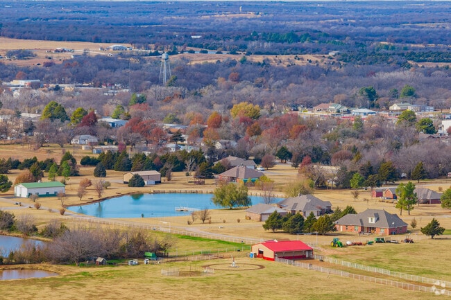 Aerial view of the Meeker neighborhood with houses and pond.