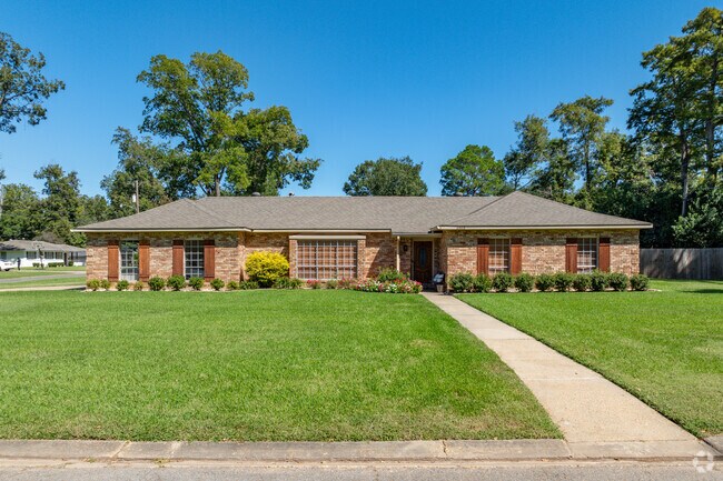 Large front lawns with manicured flowerbeds are a common sight in Four Leaf Village.