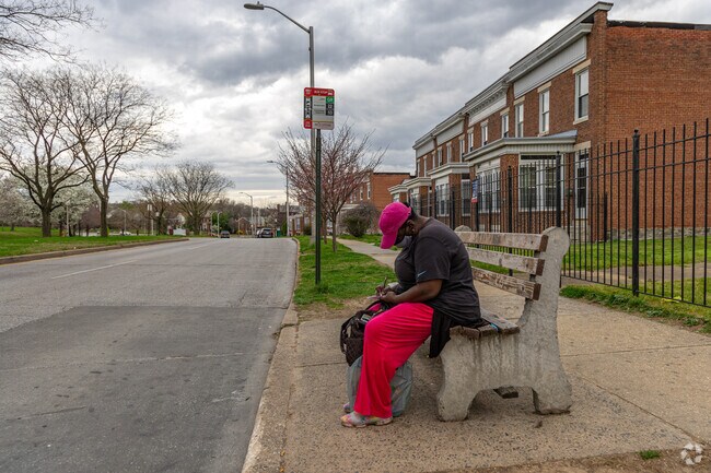 There are several bus stops along the streets for pedestrians to get around the neighborhood.