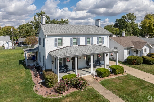 A large Neighborhood Empowerment colonial-style home is pictured above.
