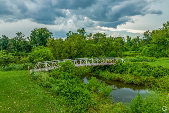 Brechtel Park bridge leads to wooded trails near Tall Timbers in Gretna, Louisiana.