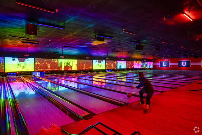 Playing a round at Bowlero, just a short drive from Cahalan, with music, lights, and glowing lanes.