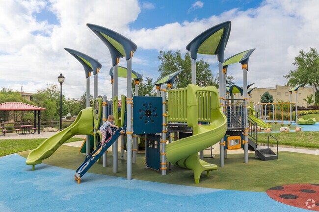 Hopper Hollow Park fills with kids swinging and sliding on the insect-themed playground.