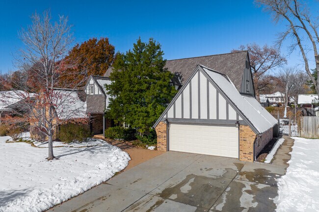 Brookhollow homes feature red brick paths, framed by trees and winter landscaping.