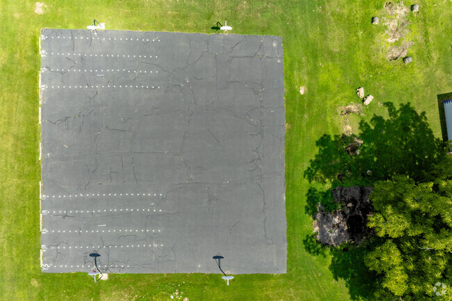 A wide lot with basketball hoops for students at Concord Middle School.