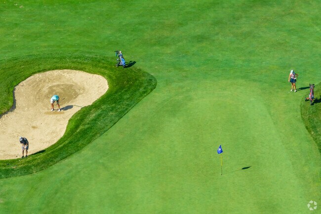 Golfers advance towards the 18th hole at The Shining Rock Golf Club in Northbridge.