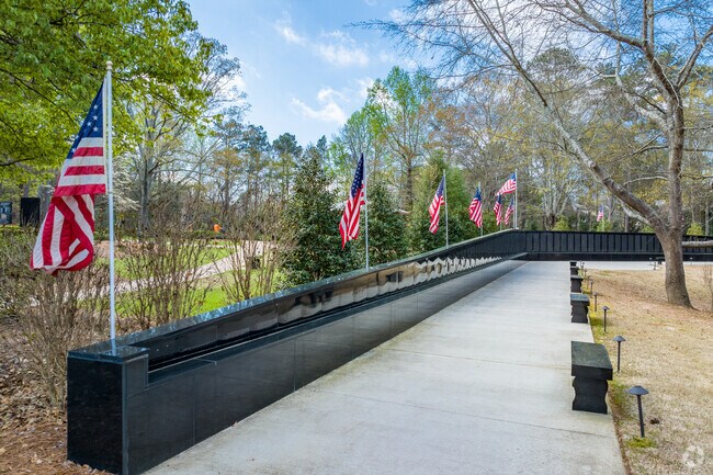 The serene Veterans Memorial Walk, located within the peaceful expanse of Newtown Park, features beautifully landscaped paths lined with vibrant flowers and commemorative plaques.