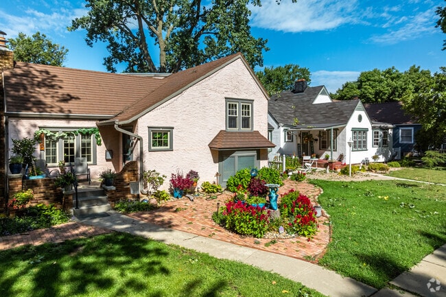 Pristine lawns with flowers and topiary line the walkways that lead to front doors in Randolph.