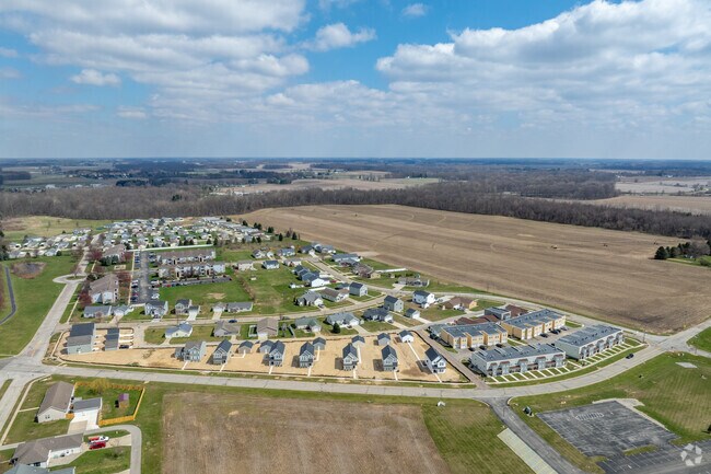 Farmland surrounds new traditional and apartment subdivisions in Plymouth.