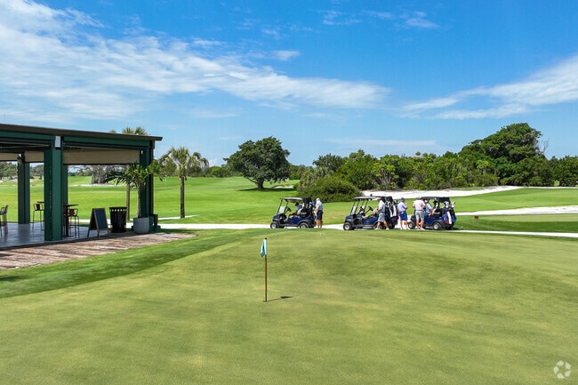 Golfers are ready to go out on their golf carts to hit the 18 hole course.