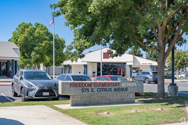 An American flag waves outside the entrance to Freedom Elementary School.