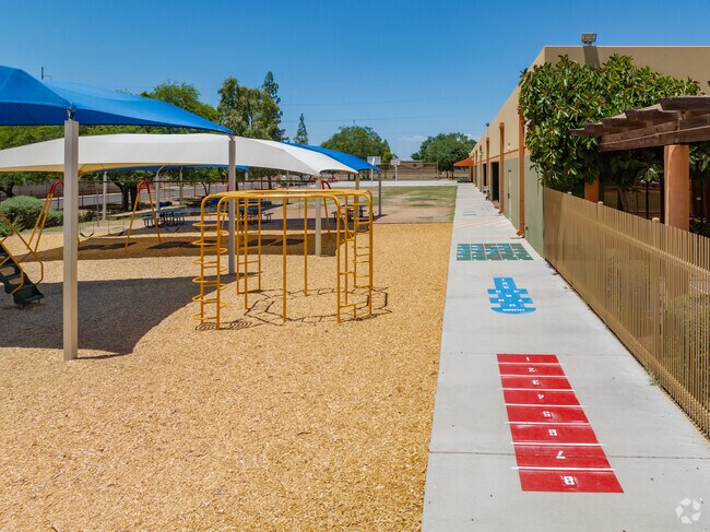 Covered playgrounds keep children safe from the sun during hot days at Painted Rock Academy.