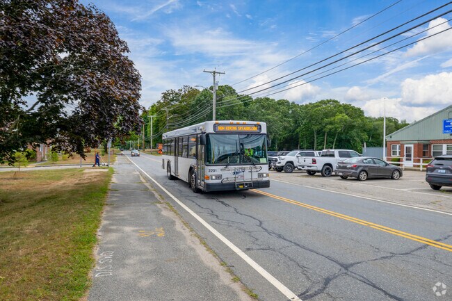 Daily life on GAR Highway in Swansea features local businesses and public transit.