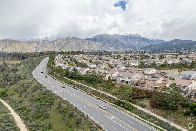 The elevated view of Yucaipa reveals newly built single-family homes nestled amidst mountains.