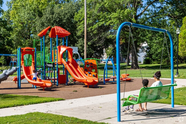 Parents can sit and relax while the kids play on the playground at Collins Park.