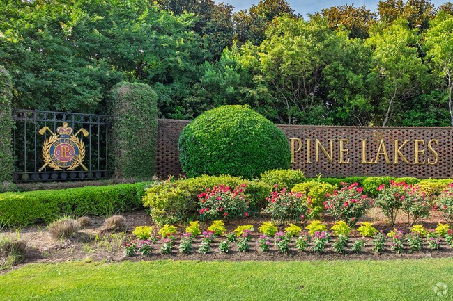 The Pine Lakes entrance sign stands near Grande Dunes, surrounded by manicured landscaping.
