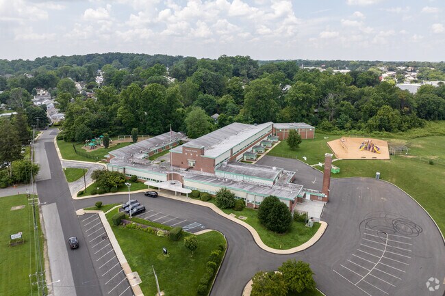 Primos Elementary School sits among a mature neighborhood of classic, brick rowhomes.
