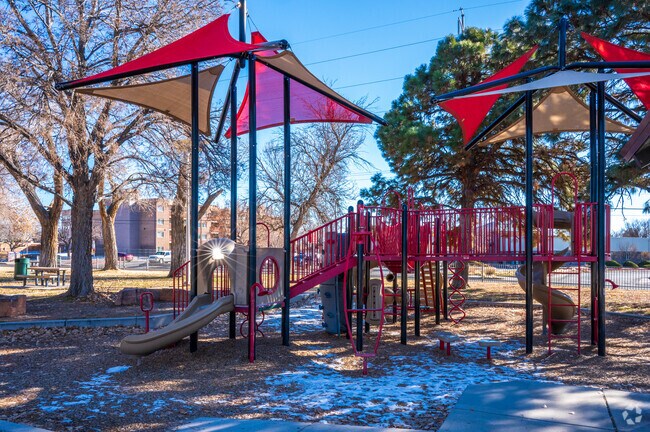 Large trees provide shade over Snow Heights Park's playground.