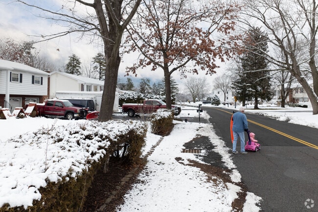 A grandpa and his girl coming back from sledding and enjoying the snow.