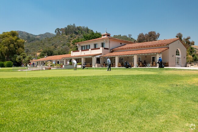 Players practice their swing at the golf course in Griffith Park of Los Angeles.