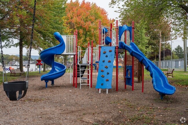 The playground at Dupont Borough Park was recently upgraded and is surrounded by trees.