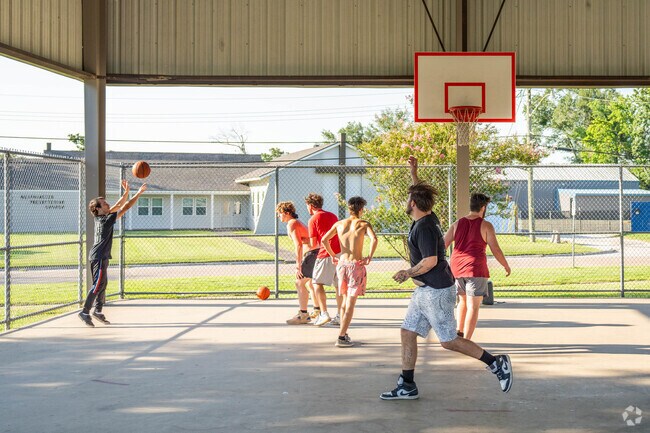 Friends shoot hoops at the shaded basketball courts at Center Circle Park in Beverly Hills.