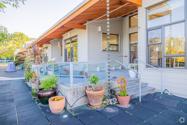Classrooms have direct access to their playfield next to the ocean.